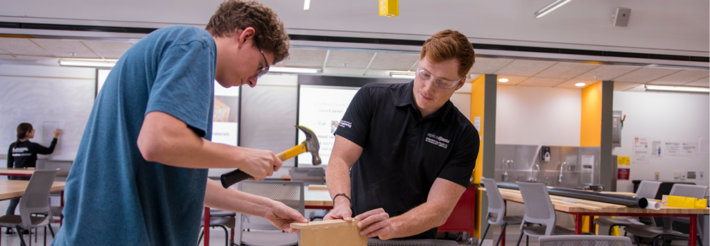 A student and faculty mentor hammering together a project
